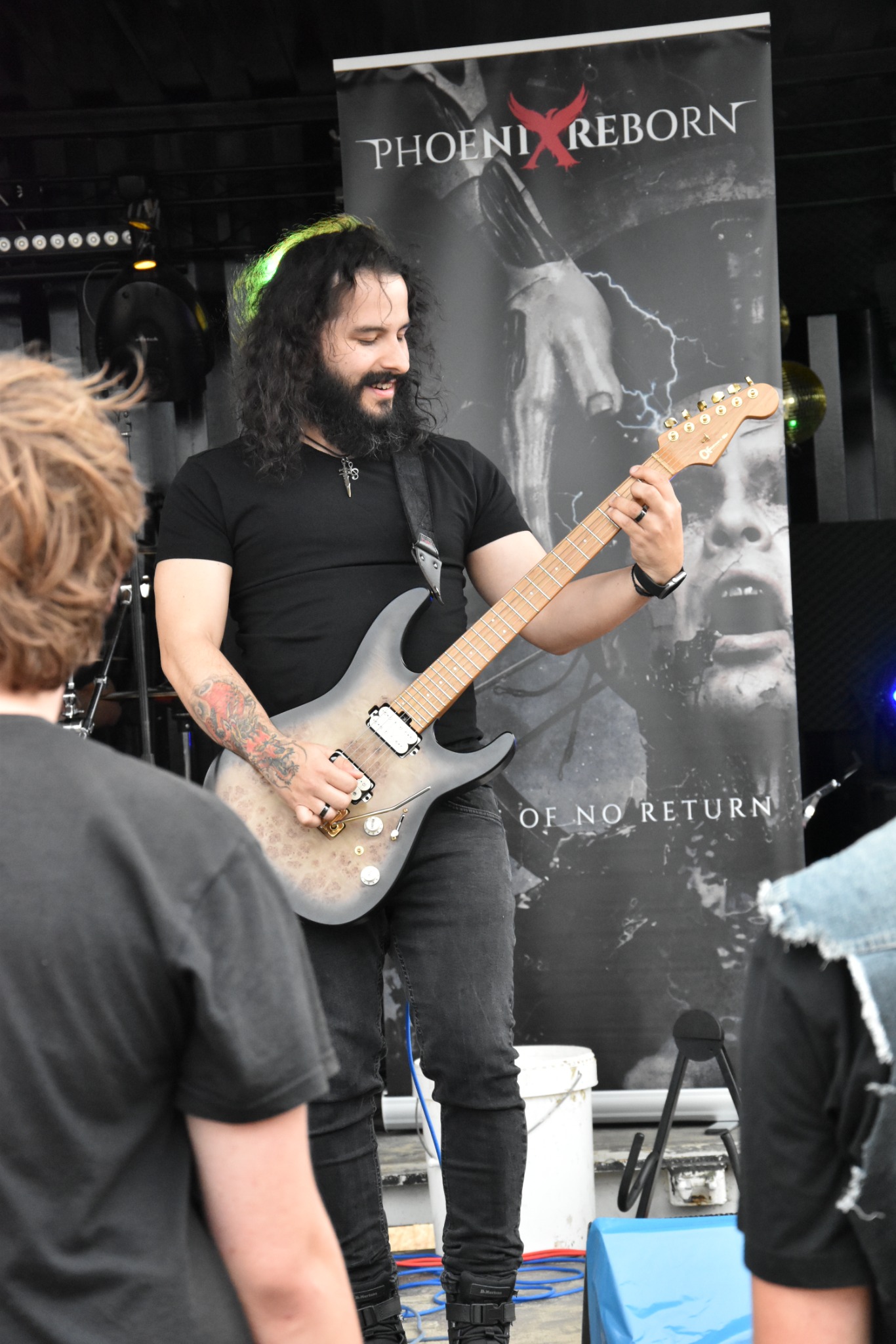 Gianfranco playing guitar on stage with Phoenix Reborn